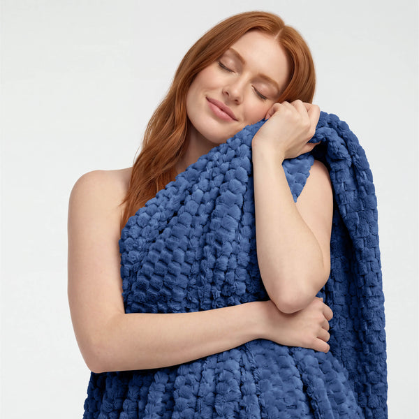A woman holding a microplush waffle blanket