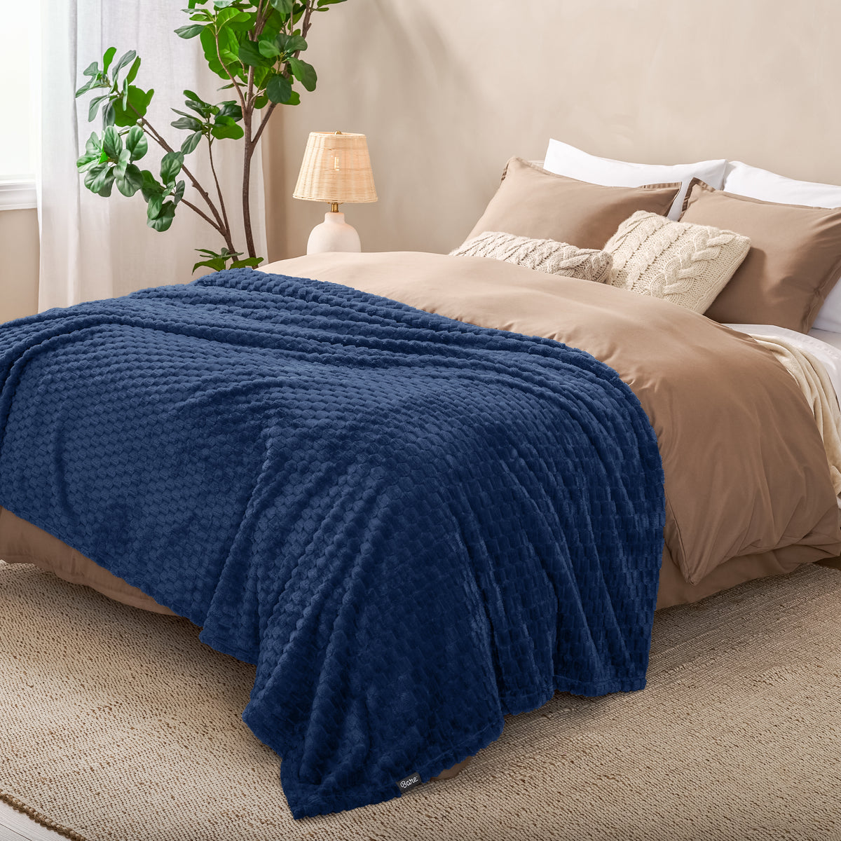 Microplush waffle blanket on a bed
