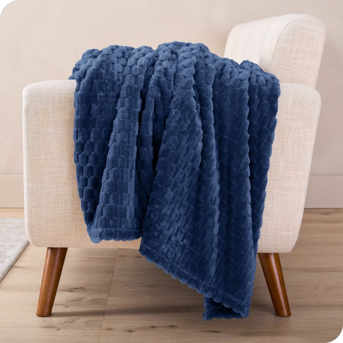 A microplush blanket draped over a chair