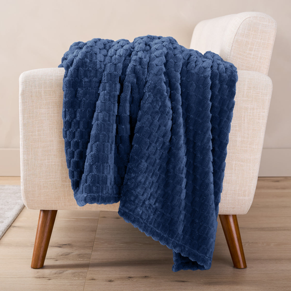 A microplush blanket draped over a chair