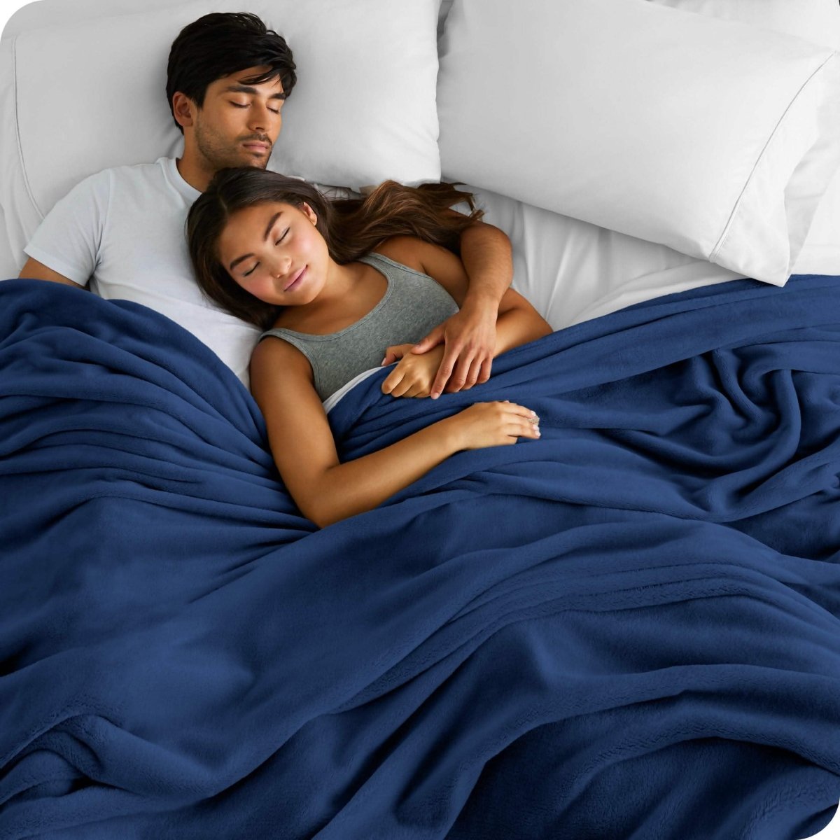 A couple sleeping with covered with a giant microplush blanket