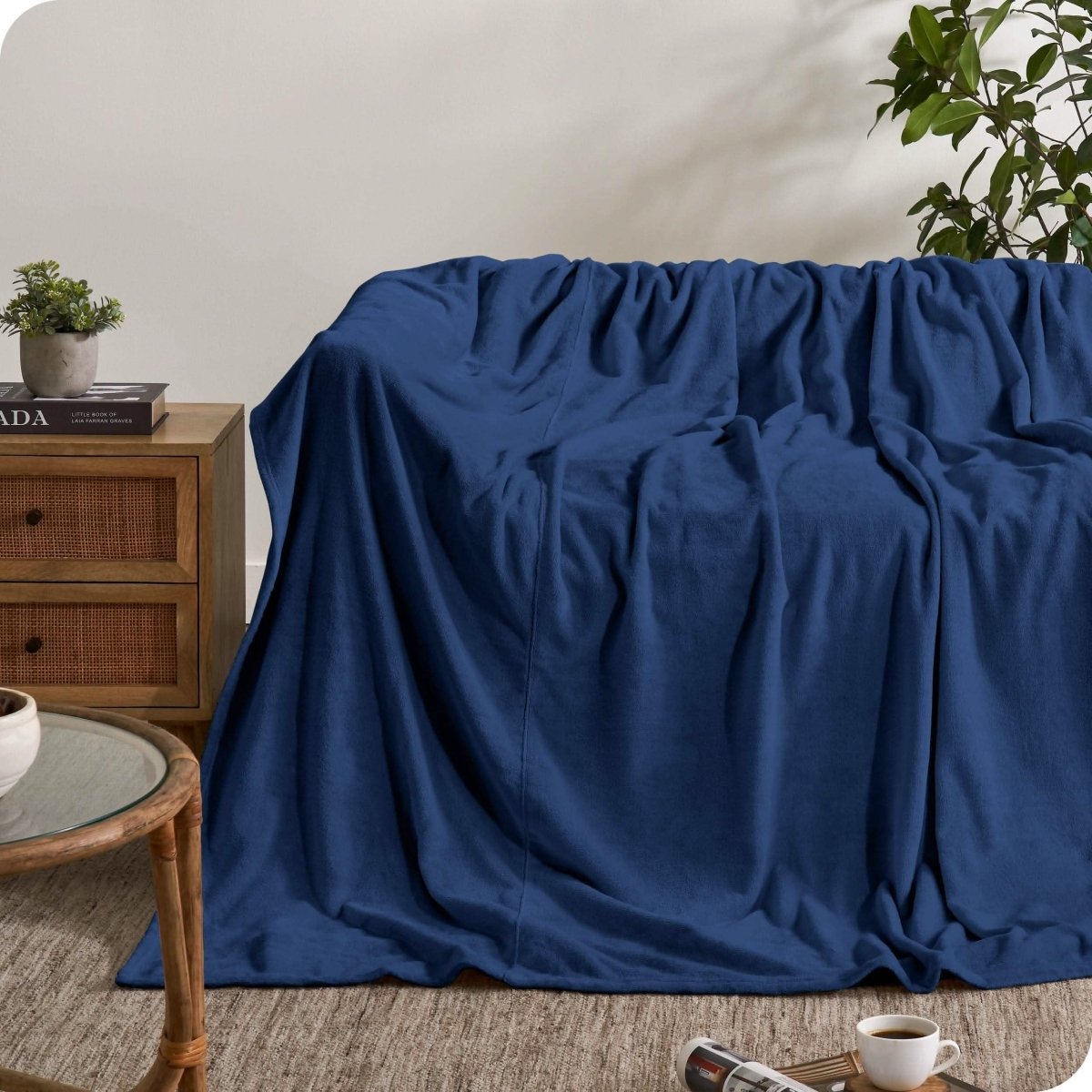 A giant microplush blanket draped over a couch