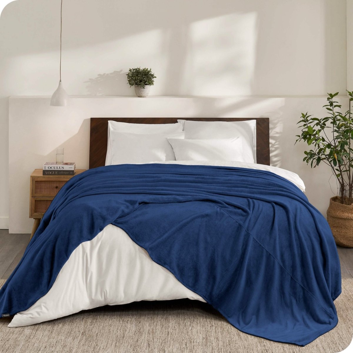 An oversized microplush blanket draped over a bed
