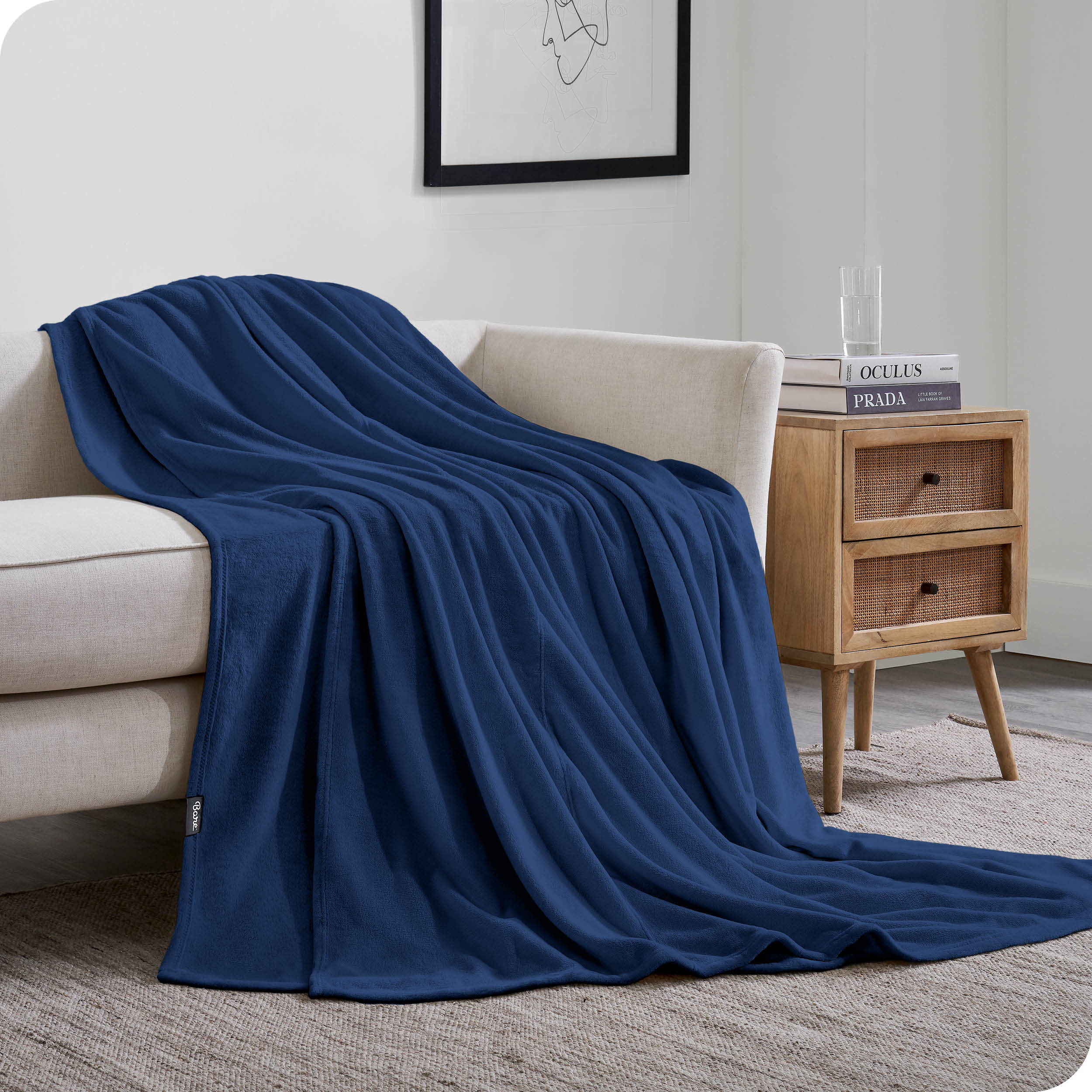 A giant blanket draped over a couch and on the floor