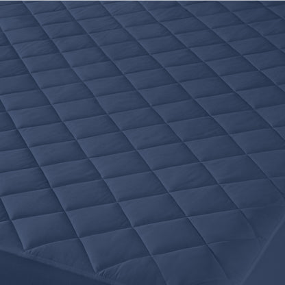 Close-up of a quilted mattress cover with a diamond pattern.