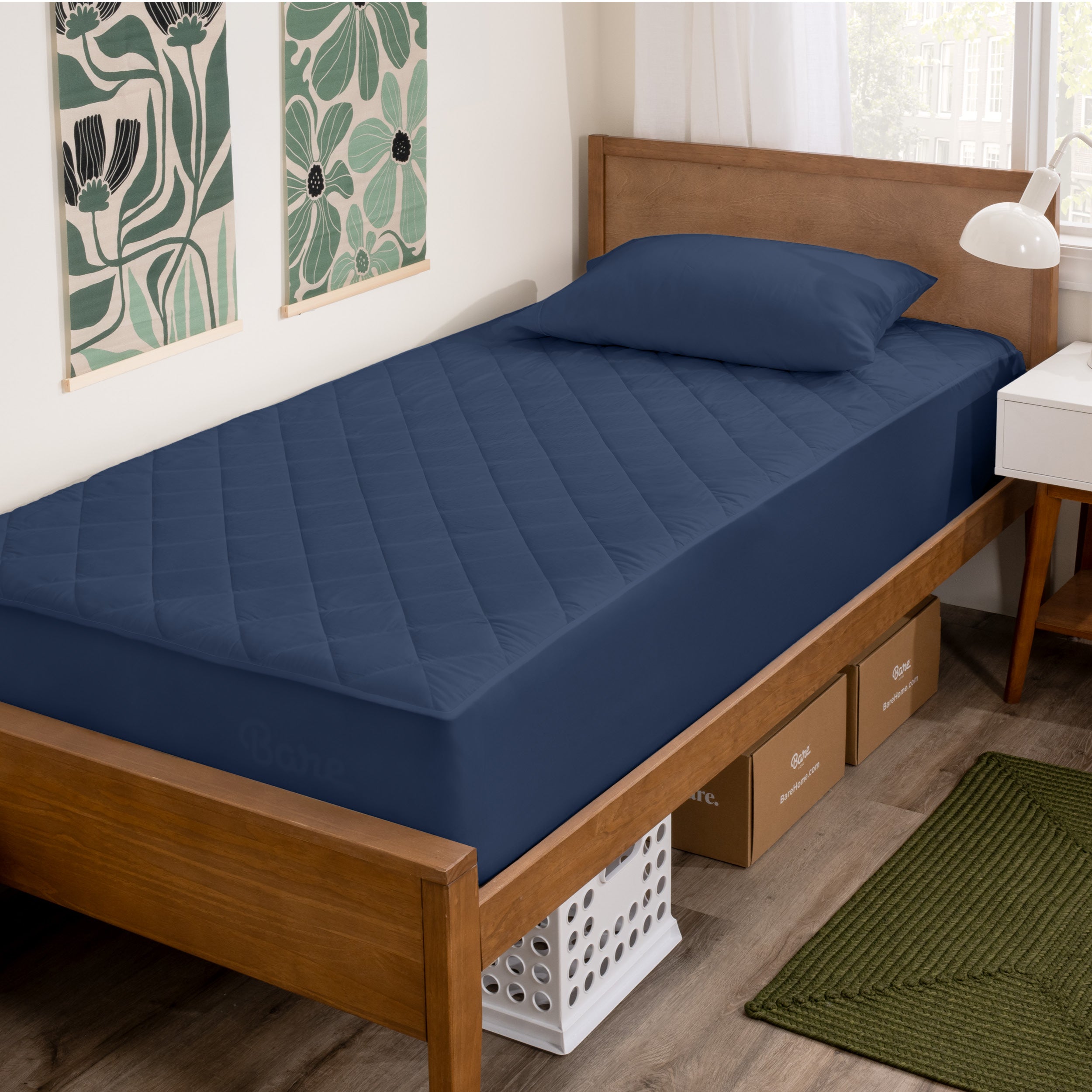 Wooden bed with dark blue mattress cover in a room with decorative elements.