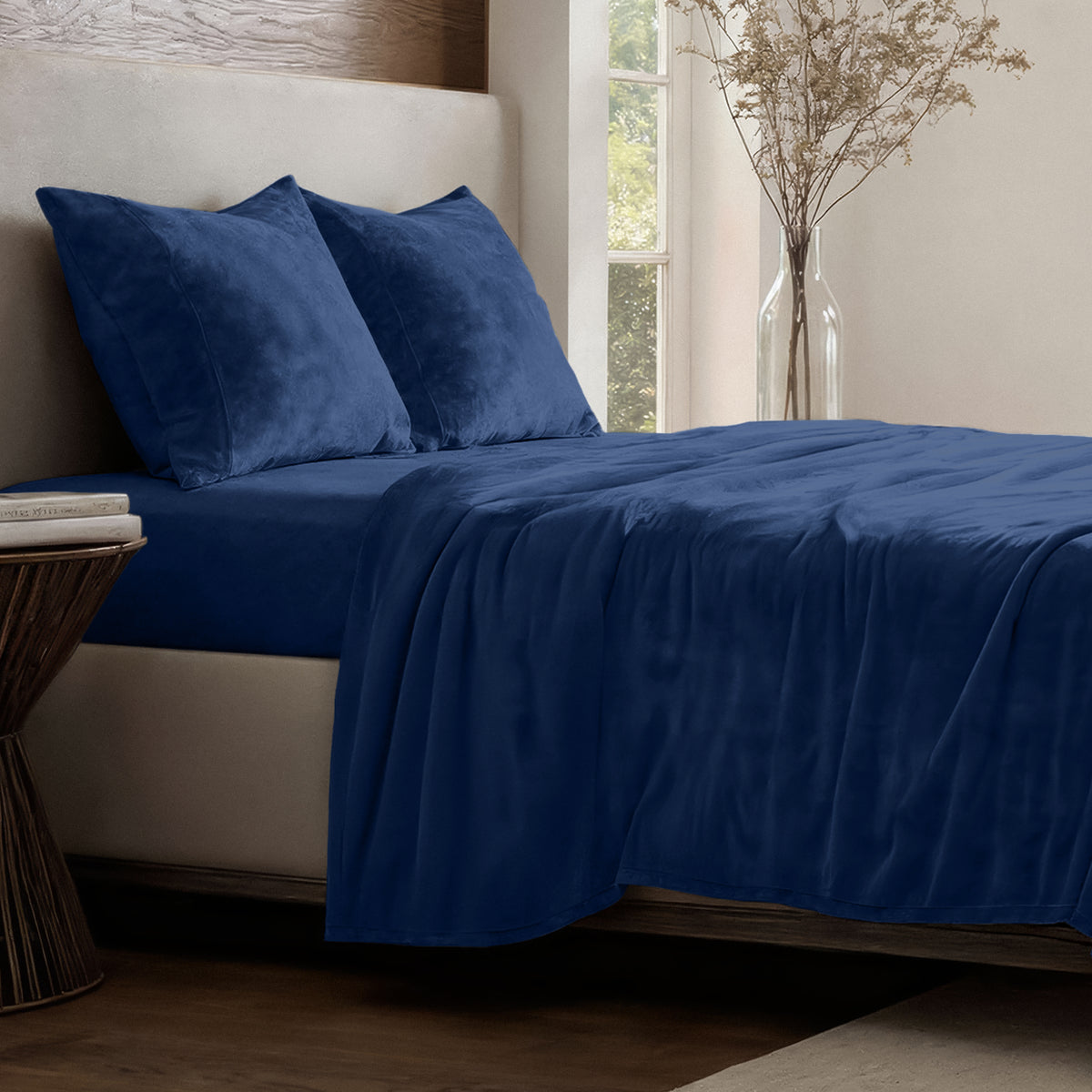 Neatly made bed in a well-lit bedroom.