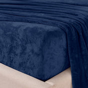 Close-up of the corner of a bed made with microplush sheets