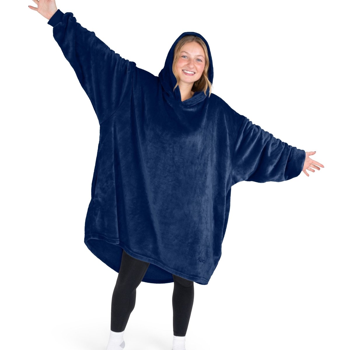 A woman wearing a hooded blanket made of microplush, showcasing comfort and warmth