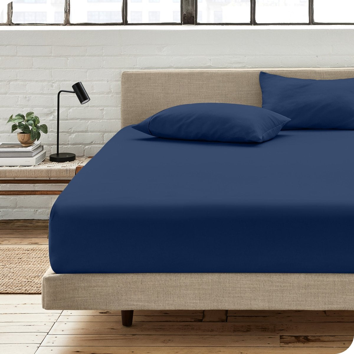 Bedroom scene with organic cotton fitted sheet and pillowcases on a bed