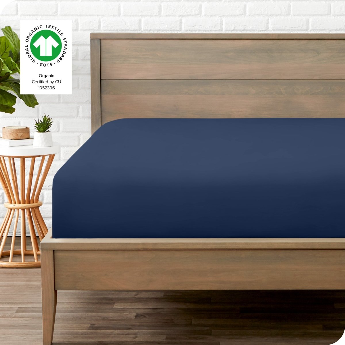 Modern wood bed frame with a sateen fitted sheet on the mattress