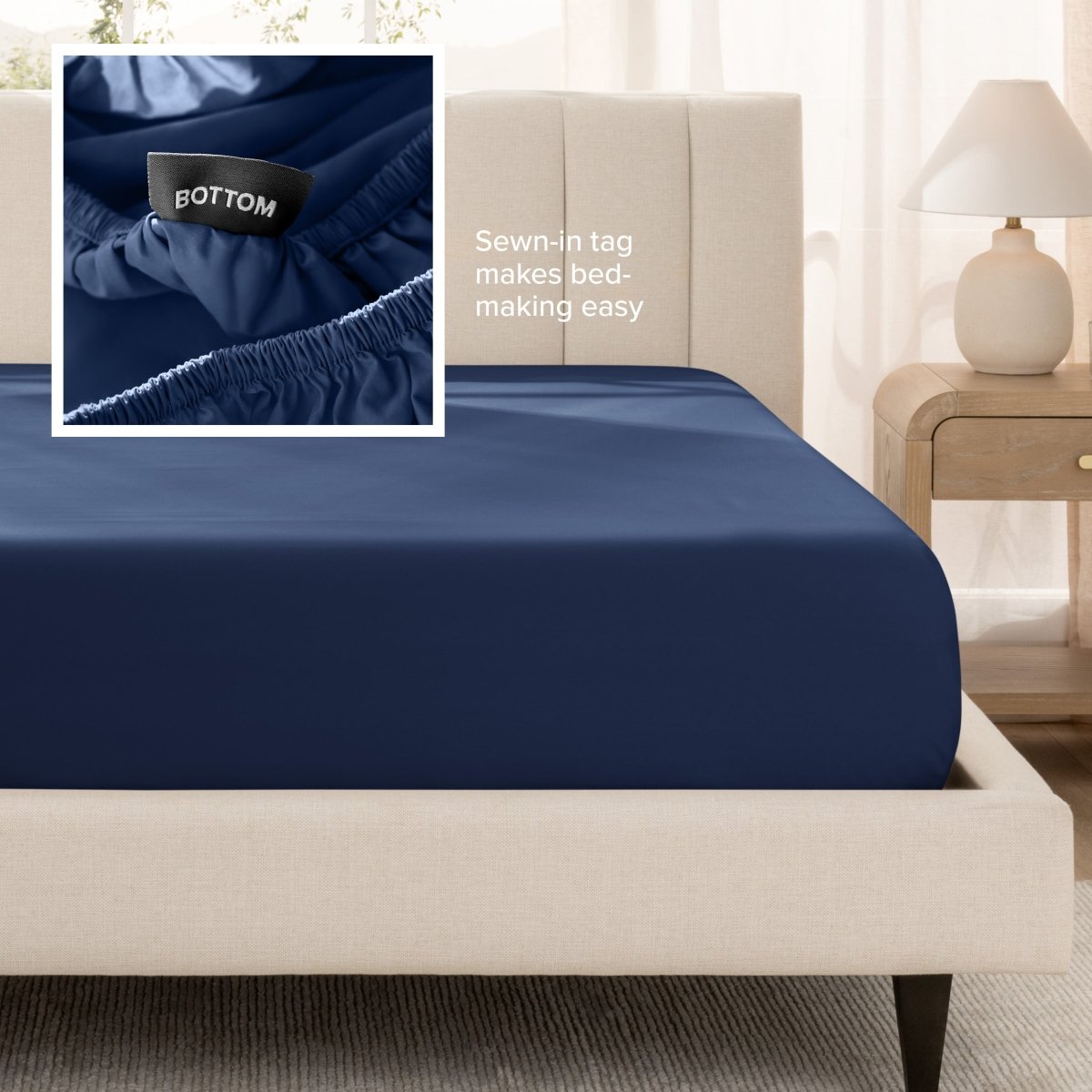 Sateen fitted sheet on a bed with a close-up of a sewn-in tag, set in a bedroom.