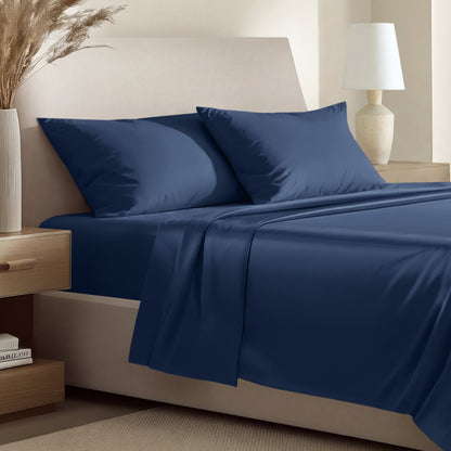 Sateen bedding set including a fitted sheet and two matching pillowcases on a bed.