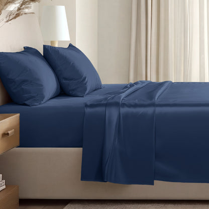 Sateen sheet set on a bed in a softly lit bedroom.