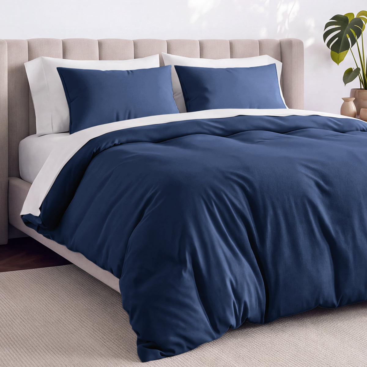 Bed with jersey duvet set against a beige headboard.