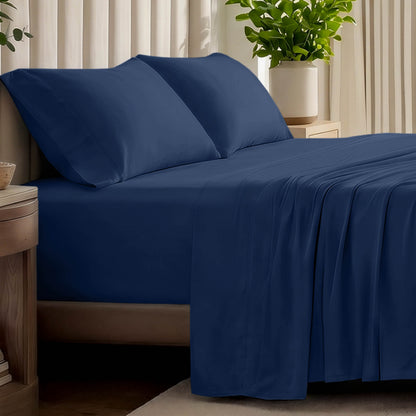 Organic jersey bed sheets and pillows on a bed with a wicker headboard.
