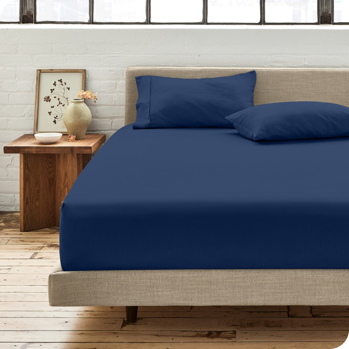 Modern bedroom with bed showing percale fitted sheet