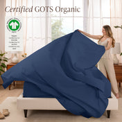 A woman is making a bed with organic cotton percale sheets