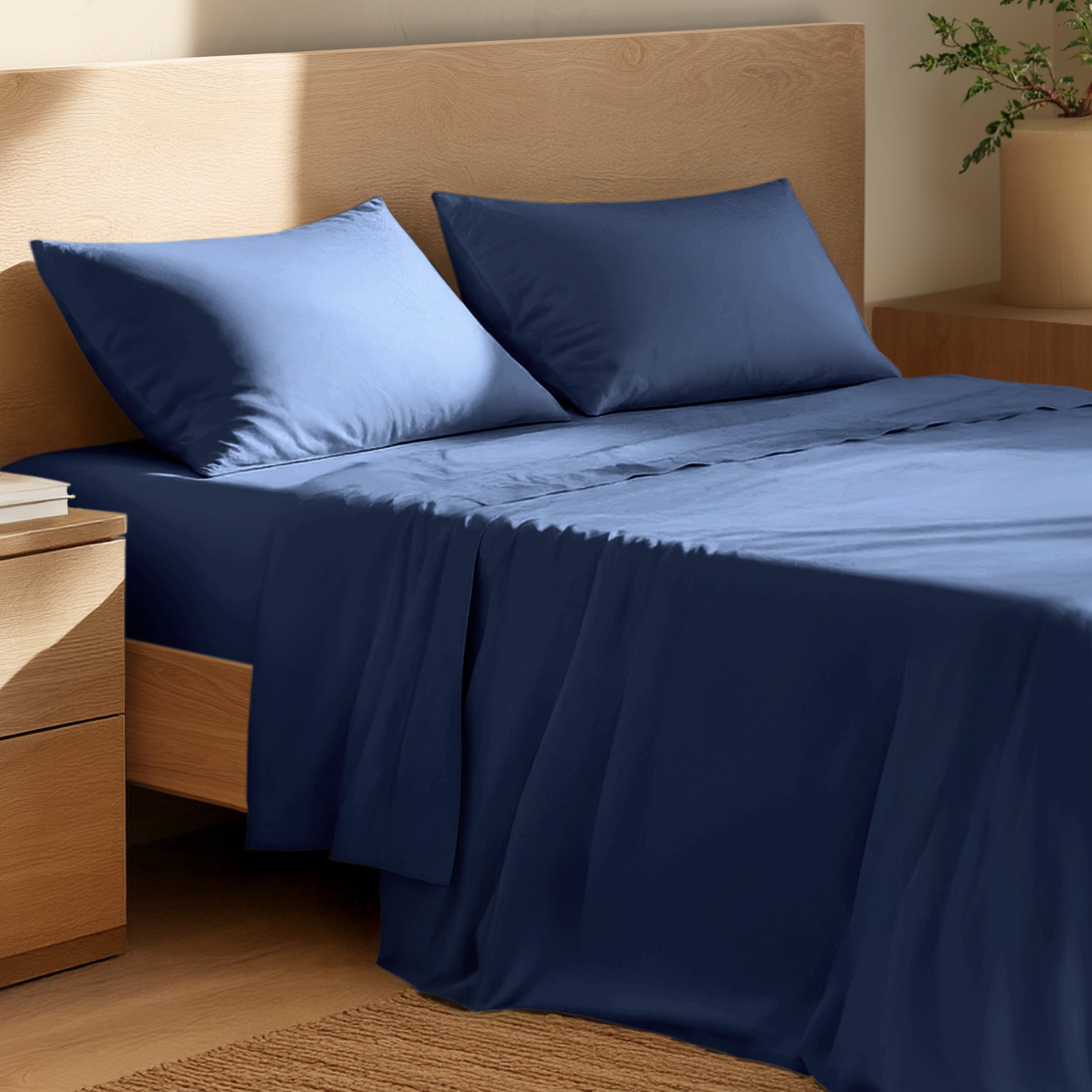 Bed with percale bedding and wooden headboard in a bedroom setting