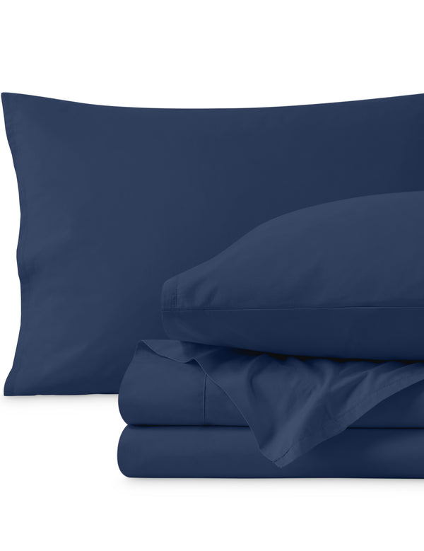 Percale sheets folded and matching pillowcases with pillows in them