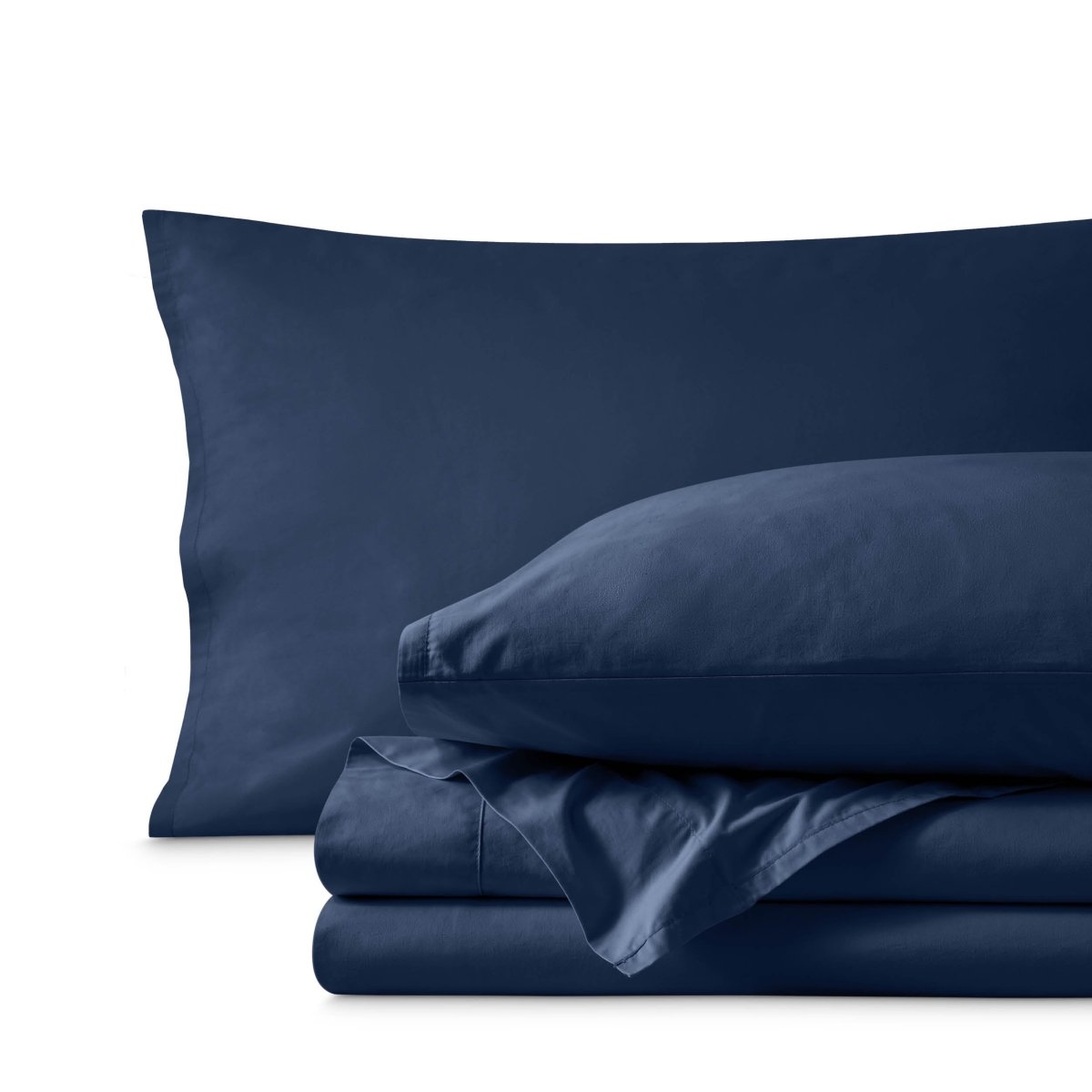 Percale bedding set including pillowcases and folded sheets arranged on a clean white background