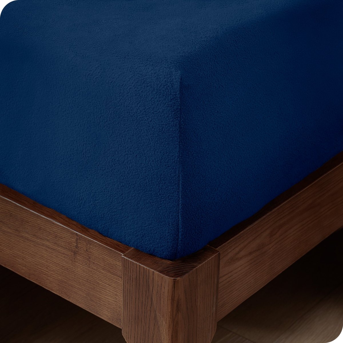 Close up of the corner of a mattress with a fleece fitted sheet on it