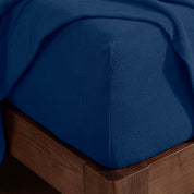 Corner of a mattress with a fitted sheet on it