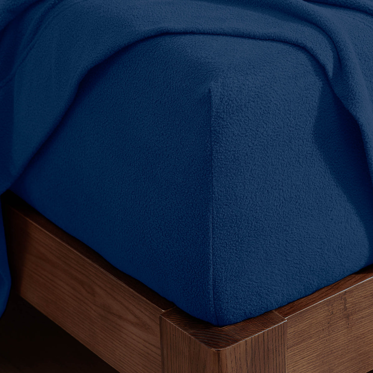 Corner of a mattress with a fitted sheet on it