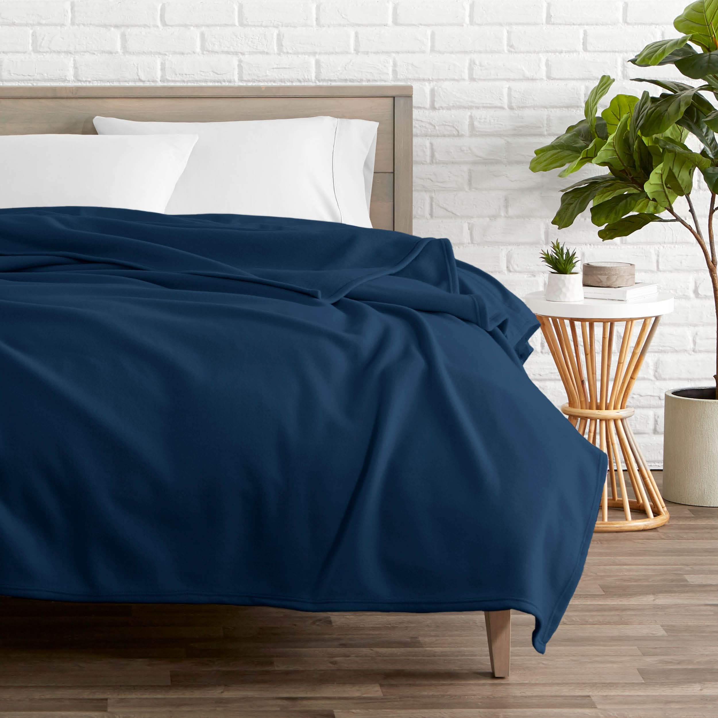 Dark blue polar fleece blanket on a bed