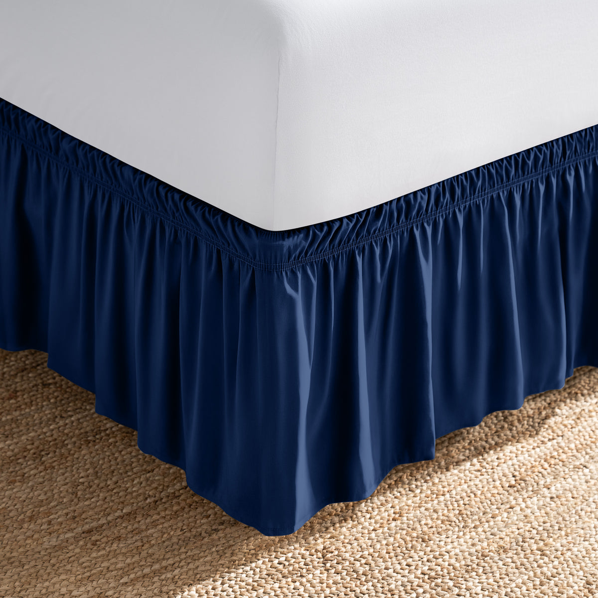 Bed with white fitted sheet and an adjustable bed skirt.
