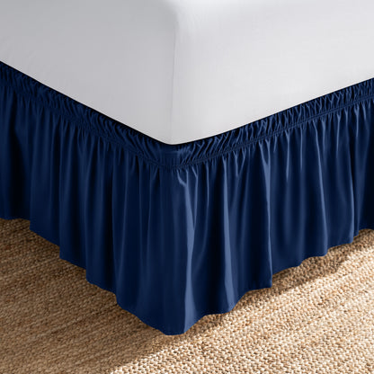 Bed with white fitted sheet and an adjustable bed skirt.