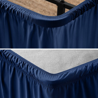 Close up of a polyester wrap around bed skirt on a bed frame and box spring