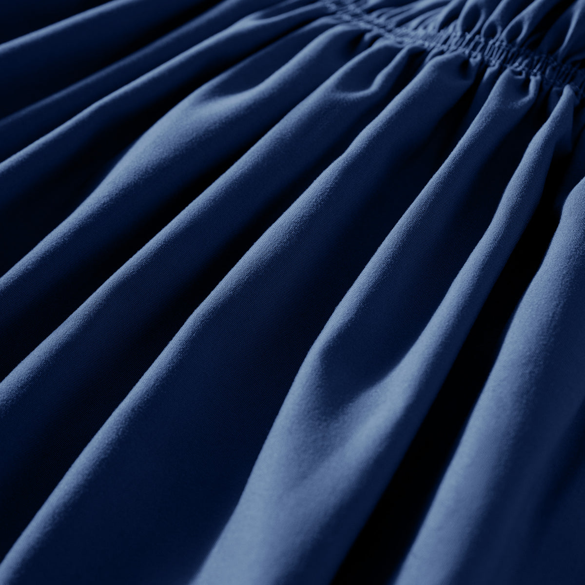 Close-up of polyester bed skirt fabric with a focus on texture and folds.
