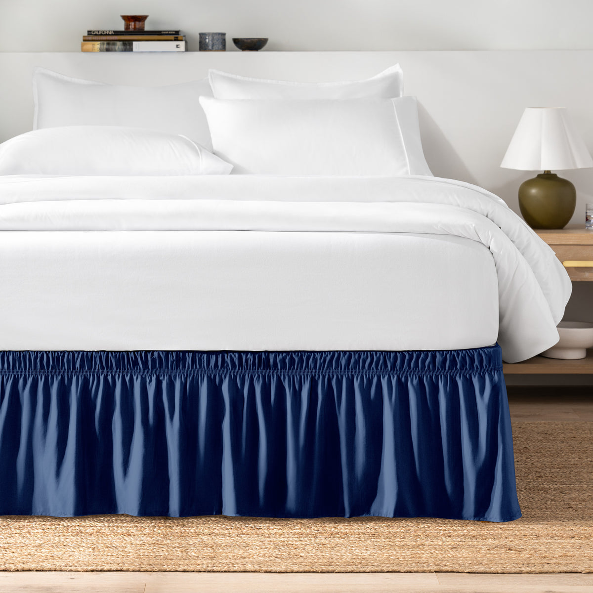 Bed with white bedding and a bed skirt.