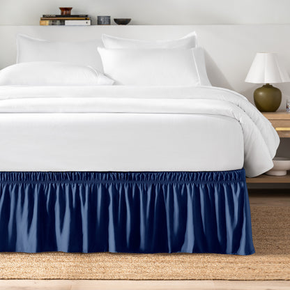 Bed with white bedding and a bed skirt.