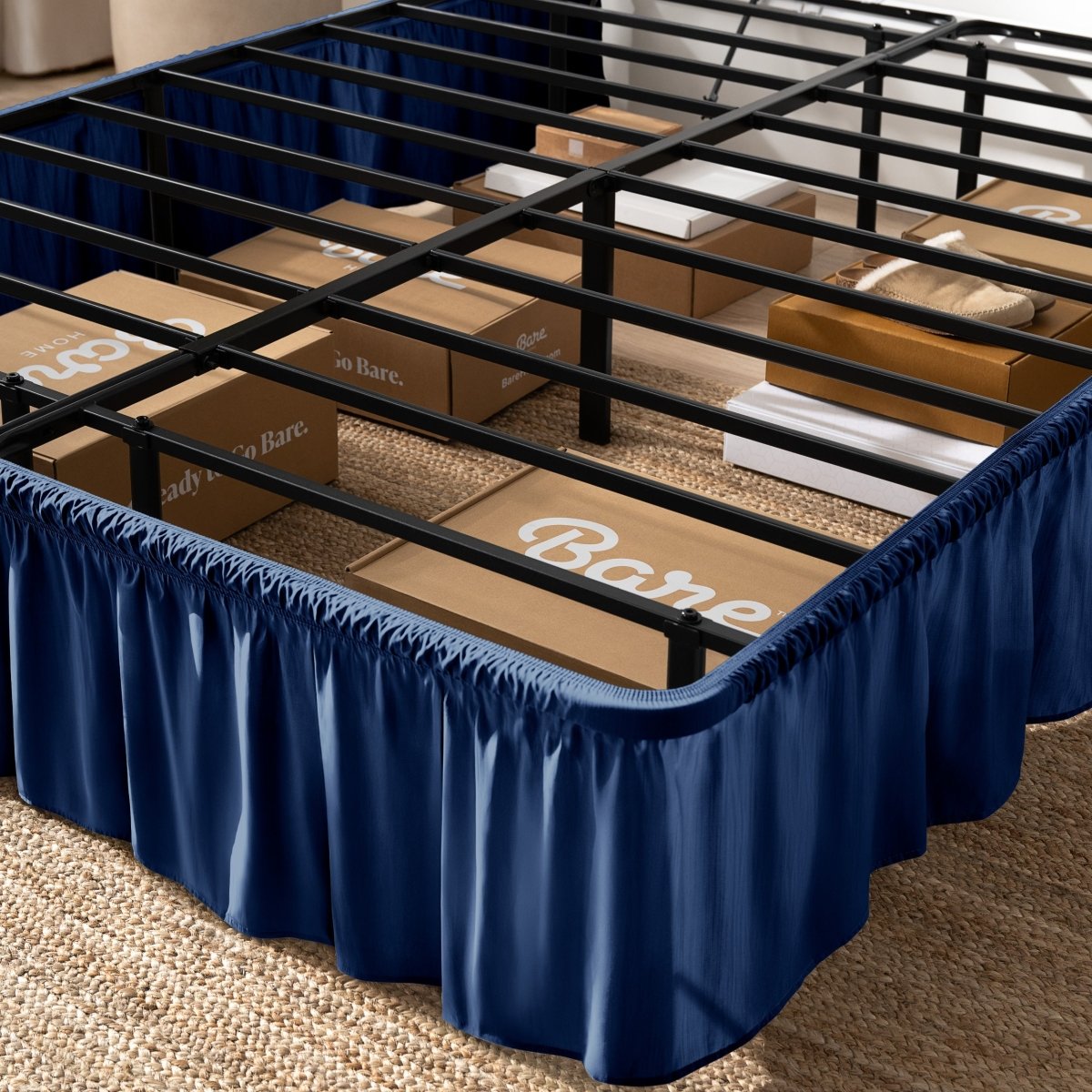Bed frame with bed skirt and Bare Home boxes underneath.