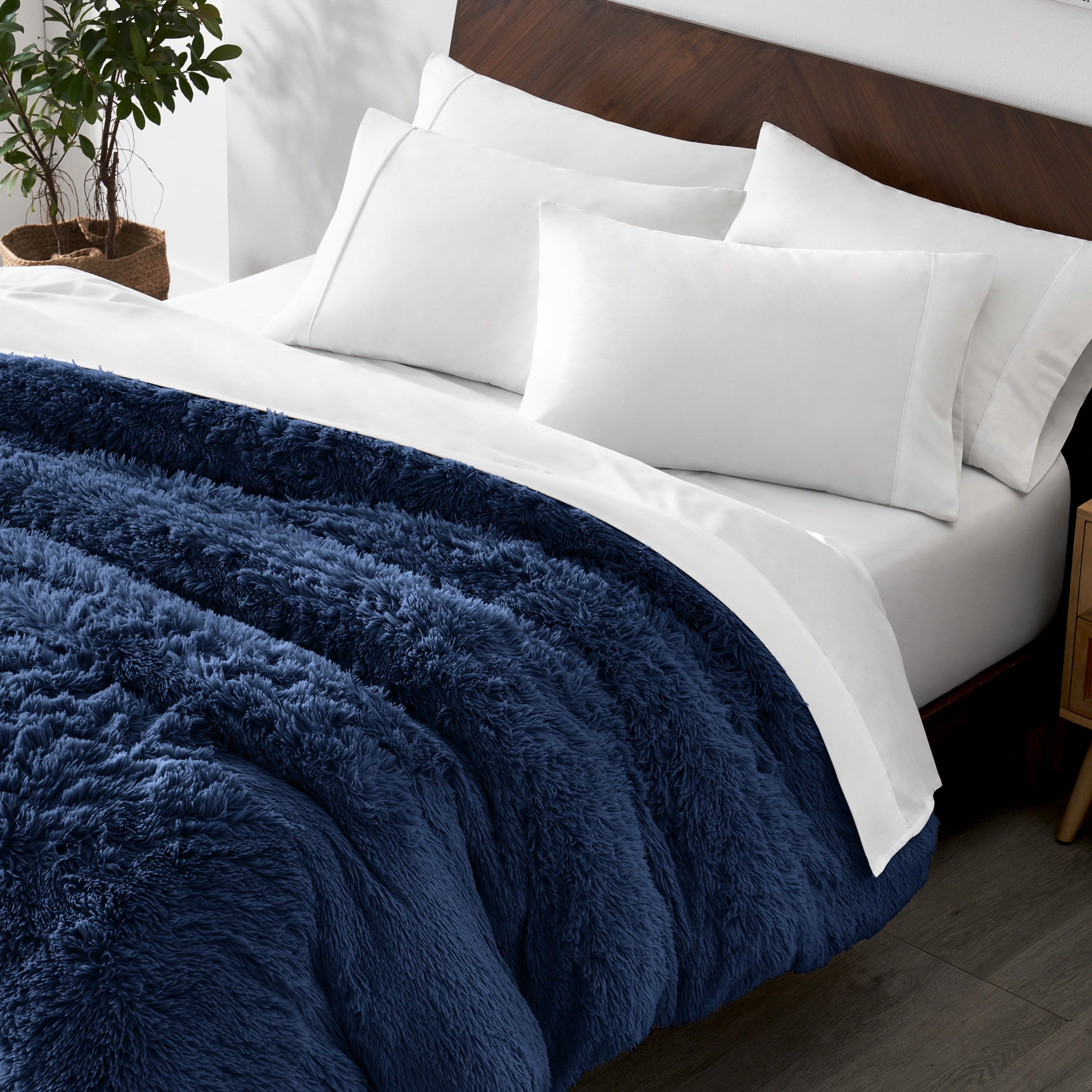 Shaggy duvet cover on a bed with white pillows and a wooden headboard.