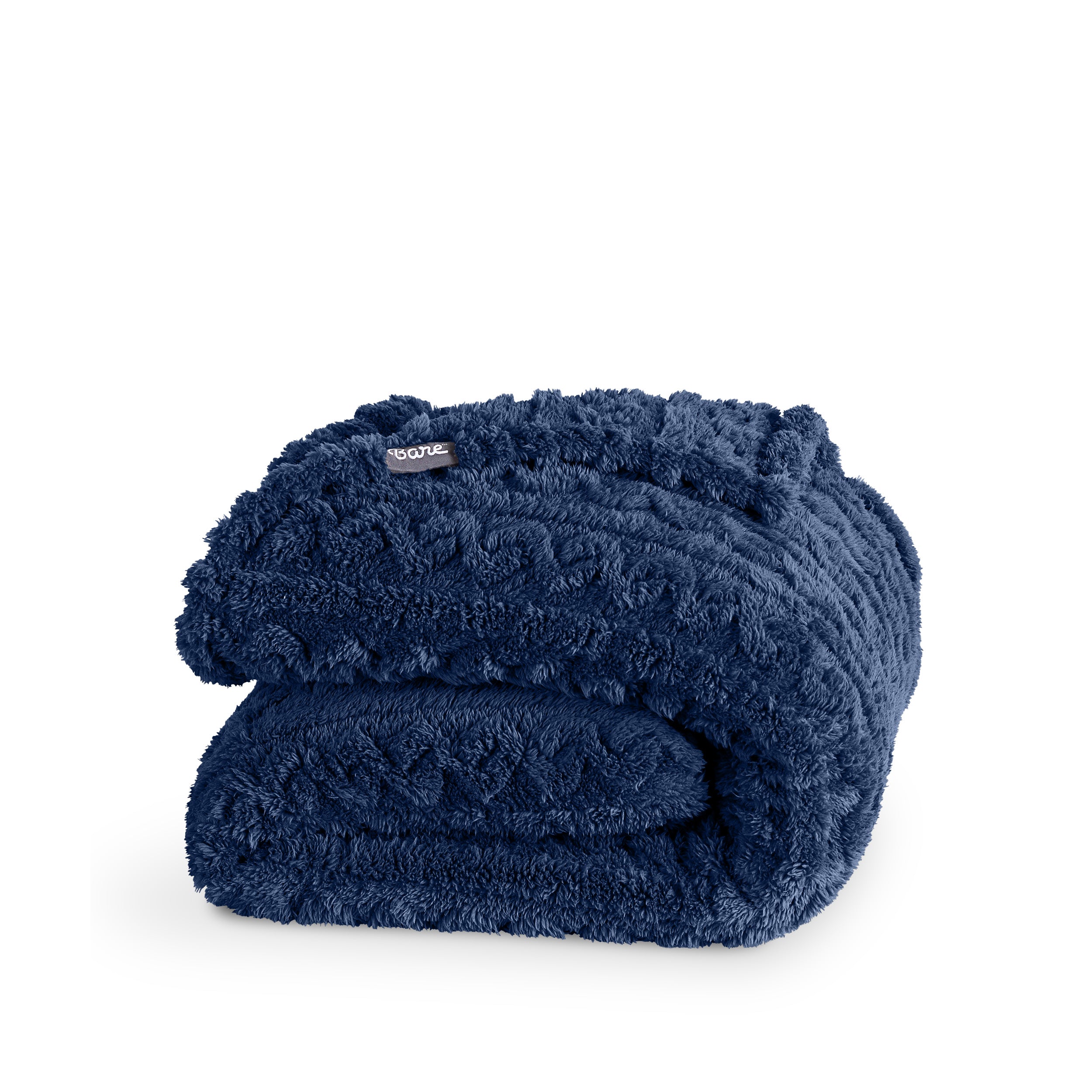 A cable knit sherpa blanket folded neatly
