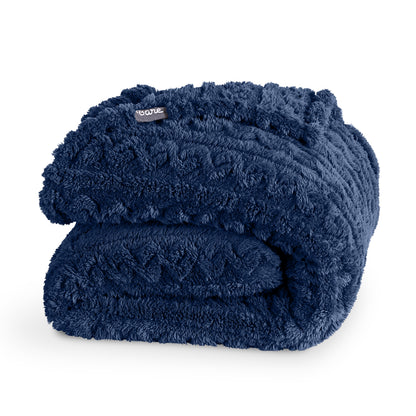 Folded blue blanket with a Bare brand tag on a white background
