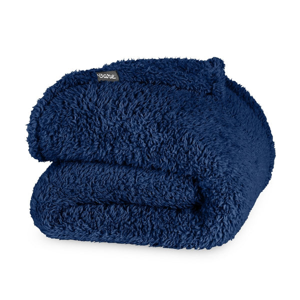 Folded textured blanket with a brand label on a white background