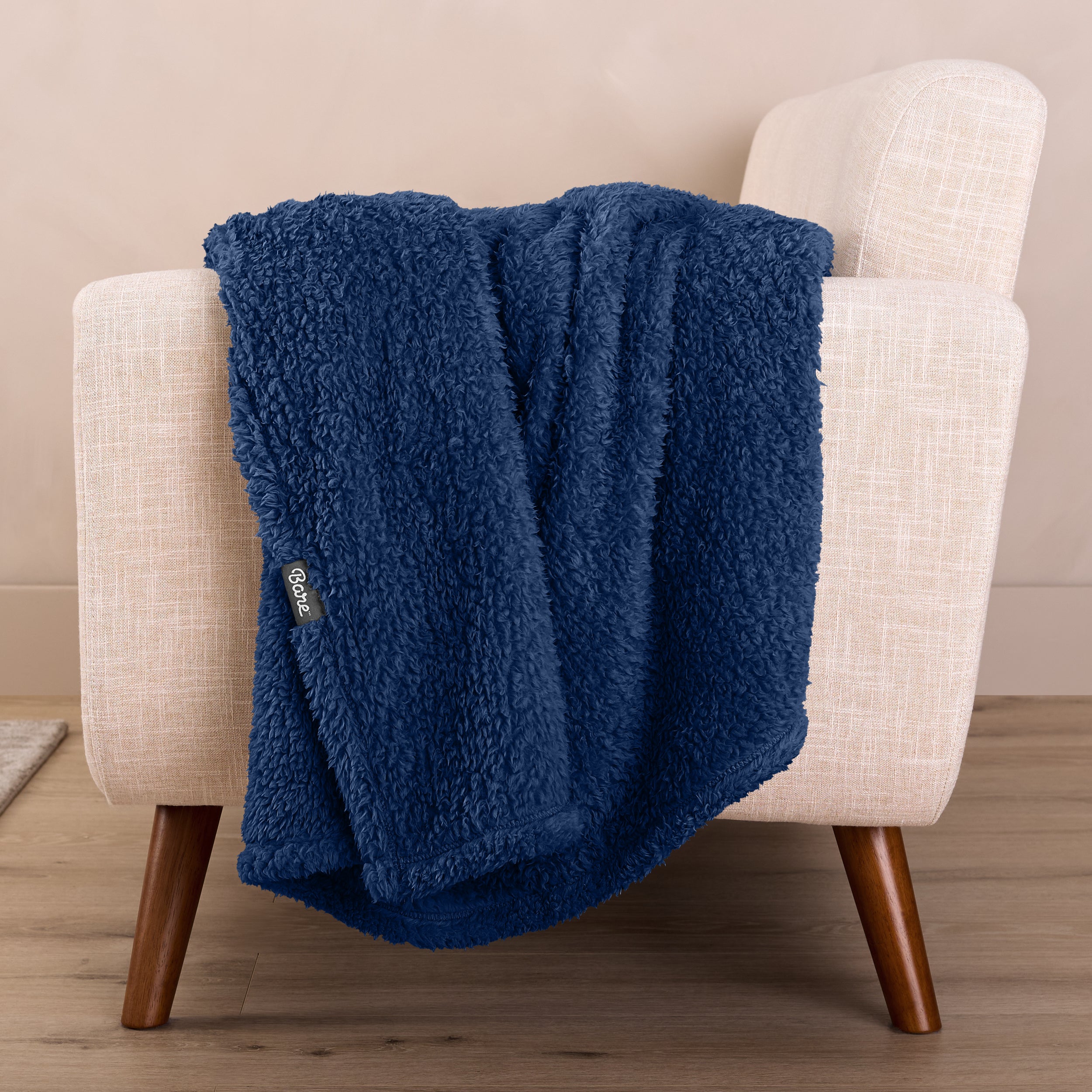 A sherpa blanket draped over a chair