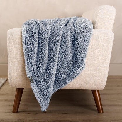 A textured blanket draped over a chair