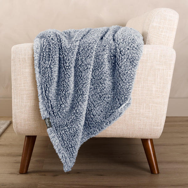A textured blanket draped over a chair