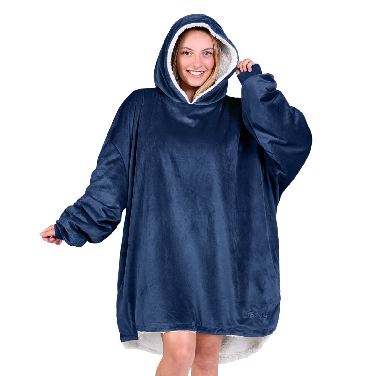An adult with a hooded wearable blanket on