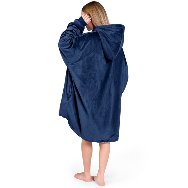 An adult with a sherpa wearable blanket on