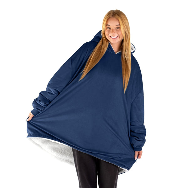 An adult with a sherpa wearable blanket on
