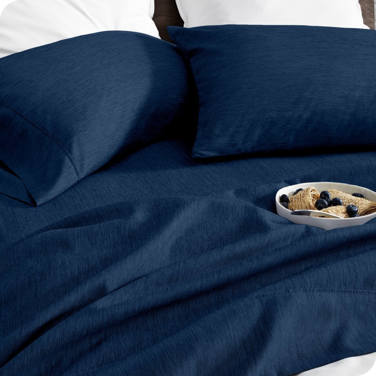 Bedding set on a bed with a bowl of cereal on a white background