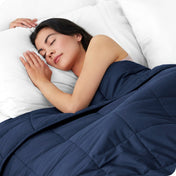 A woman sleeping with a weighted blanket over her body
