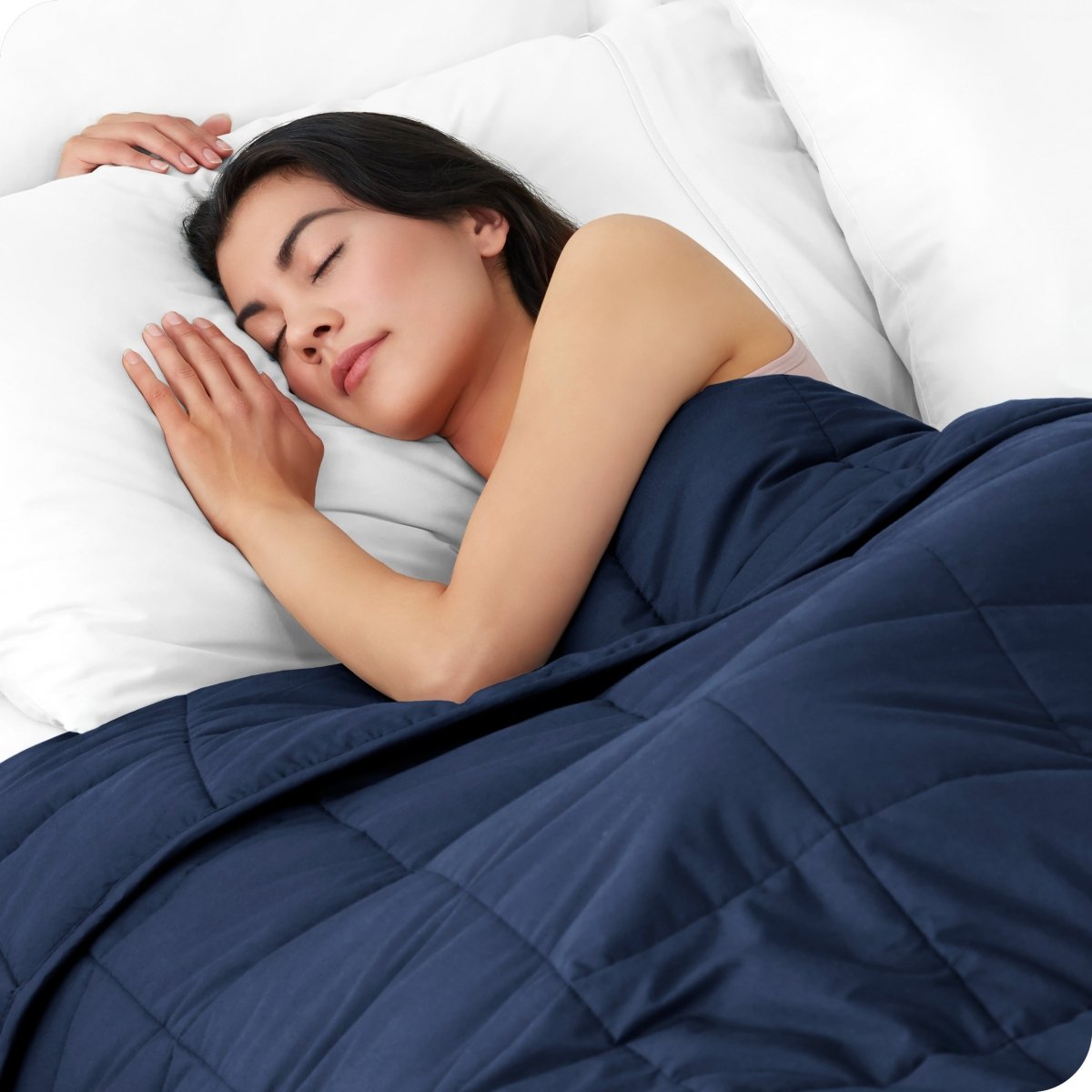 A woman sleeping with a weighted blanket over her body