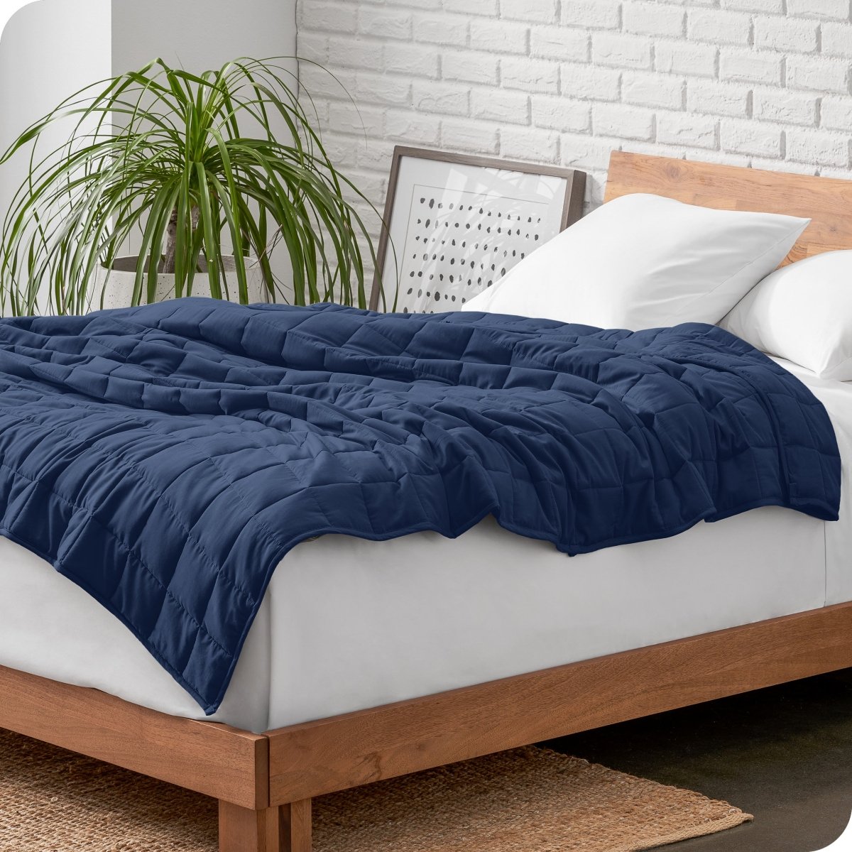 A weighted blanket draped over a bed